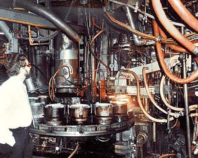 HFI Founder-CEO Dr Eric Schaffer inspects a high-volume glass press at Corning Glassworks